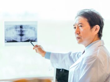 結合不全について説明する歯科医師